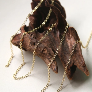 Chic gold-plated O-chain necklace for jewelry making displayed on a rustic wood stand