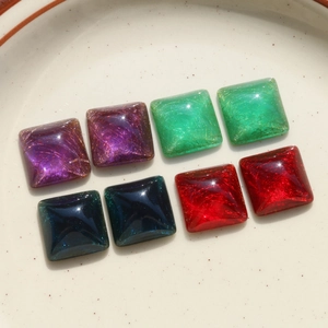 Detailed view of square resin patches with gold wire texture for DIY jewelry making