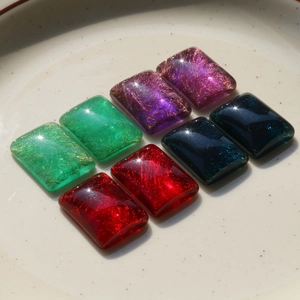 Detailed macro view of translucent square resin patches with fine gold silk textures for DIY