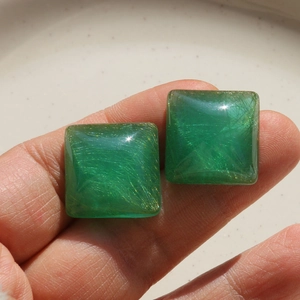 Detail of square translucent green resin cabochon with golden thread texture for DIY jewelry