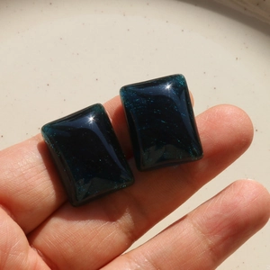 Macro view of blue translucent rectangular resin gems with gold dust for DIY crafts