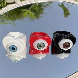 Retro heart-shaped eye rings in black, red, and white colors with realistic iris detail