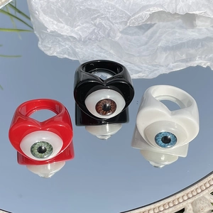 Macro shot of three gothic heart-shaped resin rings with realistic eyeball designs