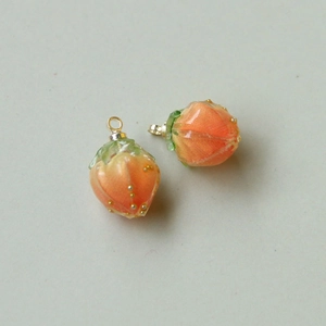Detail von erdbeerförmigen Harzanhängern mit orangefarbenem Farbverlauf für DIY-Schmuck