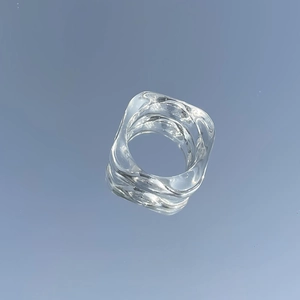 Macro shot of transparent resin ring featuring irregular wave square geometry design