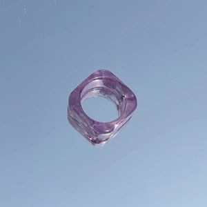 Macro view of purple square resin ring with ink smudge texture and transparent finish