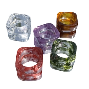 Square resin rings set with marble ink patterns in purple amber and green colors