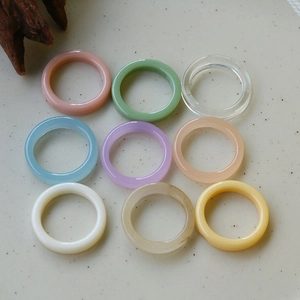 Set of 9 colorful minimalist resin stackable rings in candy colors on ceramic tray
