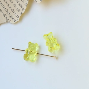 Macro shot of translucent yellow bear beads showing the horizontal hole for jewelry making