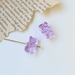 Macro shot of purple translucent gummy bear resin charms with horizontal piercing hole