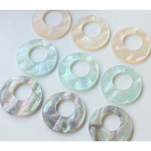 Macro detail of iridescent acetate resin rings for DIY jewelry with marble texture