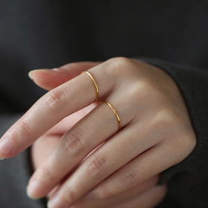 Minimalist ultra-thin gold rings with tiny zircon stone in a layered style for women