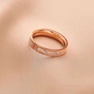 Close-up of rose gold ring with white mother of pearl inlay and small crystals