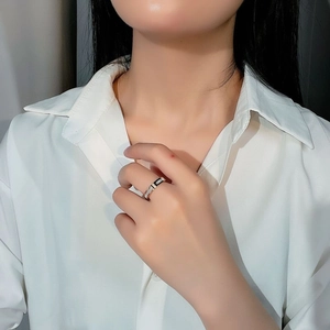 Minimalist silver steel ring with black enamel inlay and micro dot details on female hand
