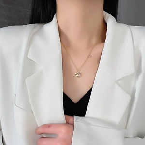 Elegant gold tiger head pendant necklace for women worn by model with white blazer