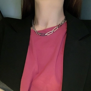 Close-up of mixed silver cuban and paperclip chain link necklace on model