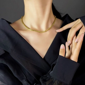 Minimalist gold titanium mesh snake chain necklace with beads on female model