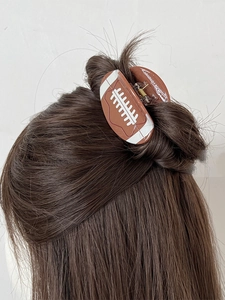 Brown American football hair claw clip for women shown styling long brown hair