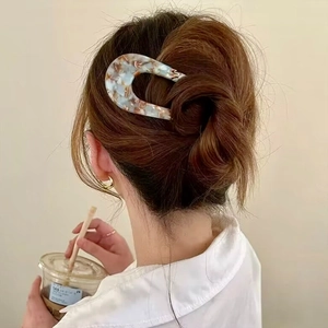 U-shaped acetate hair pin with marble texture in hair style for a sweet aesthetic