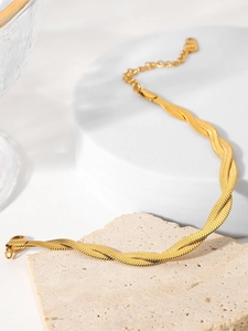Close-up of golden double-layered woven snake chain bracelet with adjustable lobster clasp