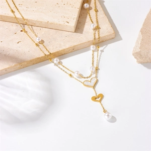 Double-layered gold titanium necklace with pearl accents and mother of pearl heart pendant