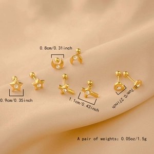 Detail view of gold heart, star, and moon screw-back studs with sparkling zircons