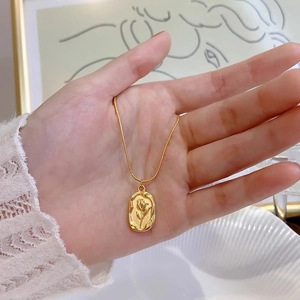 Vintage gold tulip pendant necklace with oval relief on elegant snake chain for women