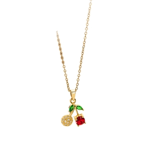 Elegant gold cherry pendant necklace with red and green gemstones on white background