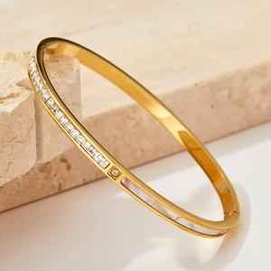 Elegant gold titanium bracelet featuring white shell inlay and square cubic zirconia accents
