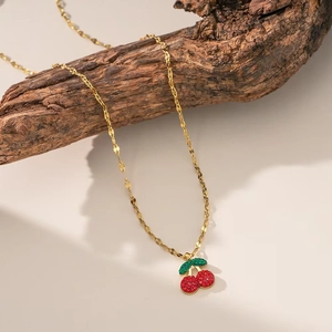 Sparkling red cherry pendant necklace with green crystal leaves on a gold twist chain