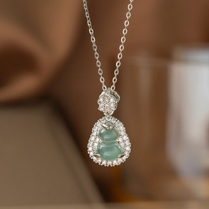 Elegante Silberhalskette mit hellgrünem Anhänger und funkelnden weißen Kristallen