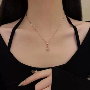 Collier en or rose avec pendentif goutte en filigrane porté par un mannequin