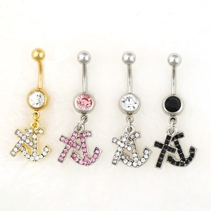 Detail view of four belly rings featuring rhinestone anchors and cross pendants