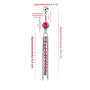 Detailed view of silver navel piercing with red rhinestones and 7cm long tassel chains