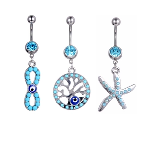 Three-piece belly ring set with tree of life, starfish, and evil eye charms in blue