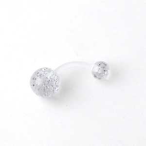 Macro shot of curved UV acrylic belly ring with silver glitter balls and flexible clear bar