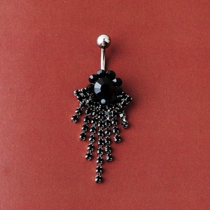 Detailed view of belly ring featuring black crystal flower and long tassel rhinestones
