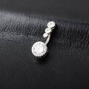 Silver navel piercing ring with large round white zircon and three small stones on a bar