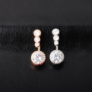 Macro view of rose gold and silver belly rings with sparkling cubic zirconia stones