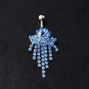 Blue rhinestone flower navel ring with long tassel dangles on black leather background