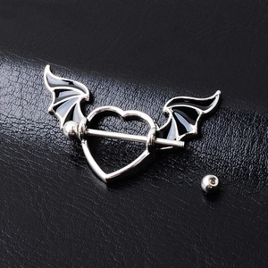 Gothic heart-shaped nipple ring with black bat wings on black leather background