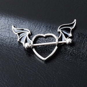Gothic surgical steel nipple barbell with heart and black bat wings on leather background
