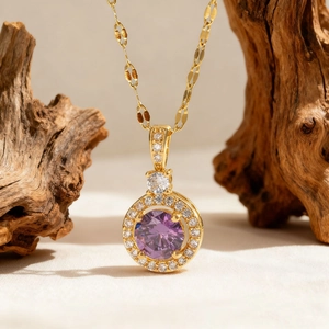 Elegant 18K gold plated necklace featuring a faceted purple zircon heart pendant with pavé crystals