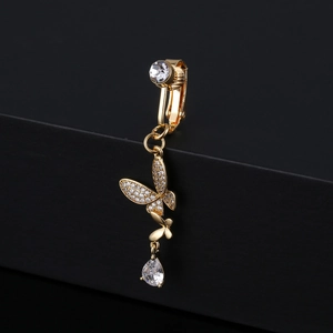 Detailed close-up of golden butterfly navel ring with sparkling zircon stones