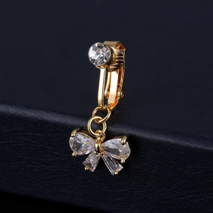 Detailed view of a golden butterfly belly ring with sparkling zircon stones and crystals