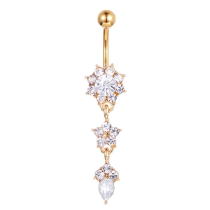 Detail of gold floral belly ring with sparkling crystals and long teardrop pendant