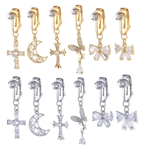 Golden and silver clip-on earrings set with zircon crosses, butterflies and moon charms