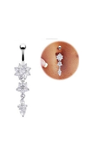 Macro detail of silver dangling belly ring featuring three sparkling floral crystal clusters