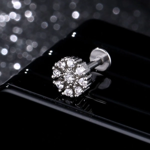 Surgical steel star and moon ear studs with clear cubic zirconia on a black stand