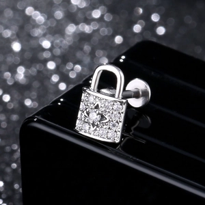 Macro shot of silver padlock labret stud with cubic zirconia inlays and flat back post